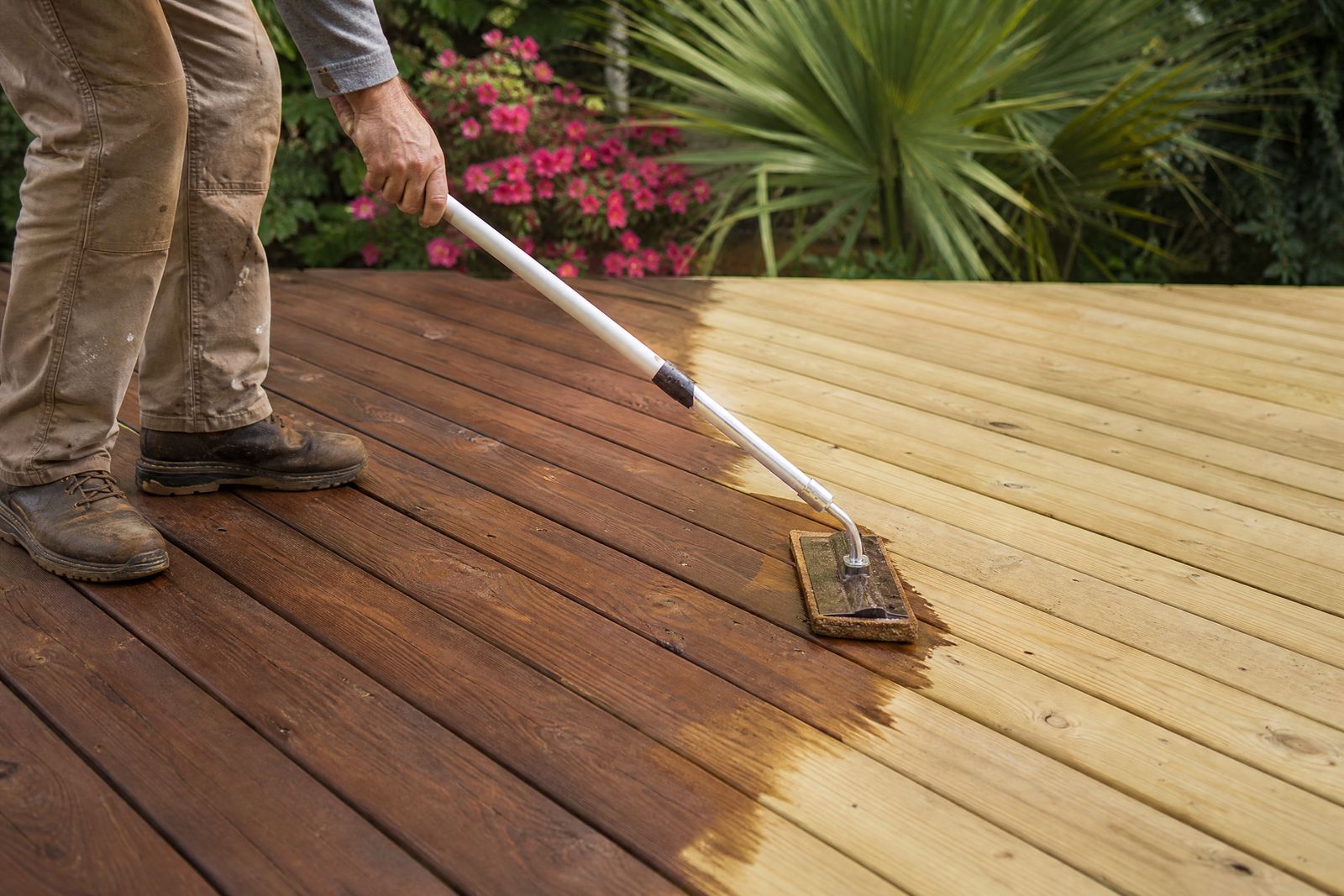 Semi-transparent cedar stain being applied to freshly sanded deck boards in Charleston, SC